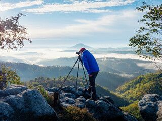 Photographer framing scene in viewfinder. Man use digital camera in hands