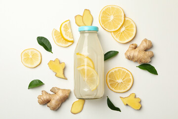 Bottle of ginger lemon water on white background