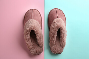 Pair of stylish soft slippers on color background, flat lay
