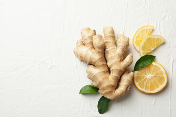 Fresh raw ginger and lemon on white background