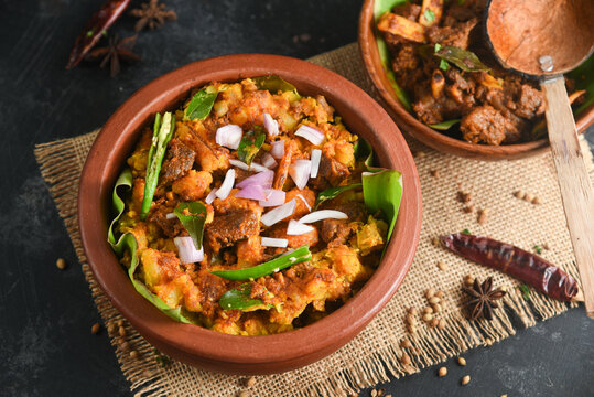 Kappa Puzhukku kappa biryani Cooked tapioca , Cassava root , Mandioca , Aipim with spicy fish meat beef pork curry, Kerala India. Prepared South Indian food, served with chutney. root vegetable Brazil