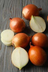 Fresh raw onion on wooden background, close up