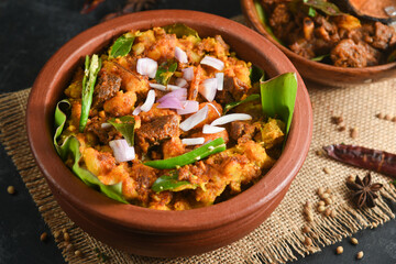 Kappa Puzhukku kappa biryani Cooked tapioca , Cassava root , Mandioca , Aipim with spicy fish meat beef pork curry, Kerala India. Prepared South Indian food, served with chutney. root vegetable Brazil