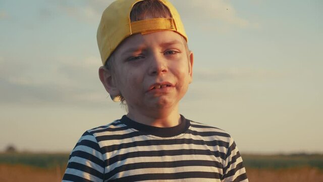 boy kid crying flowing tears a screaming dirty face. child son scream disappointed cranky. domestic lifestyle violence concept. close-up toddler roared all in tears