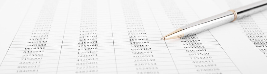 Pen with Financial accounting graphs. Finance, business and accounting concept.