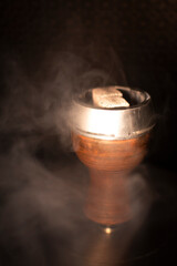 hookah bowl with coals in the smoke