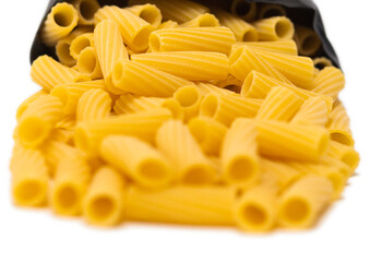 pasta close-up on a white background. Pasta spilled out of the package.