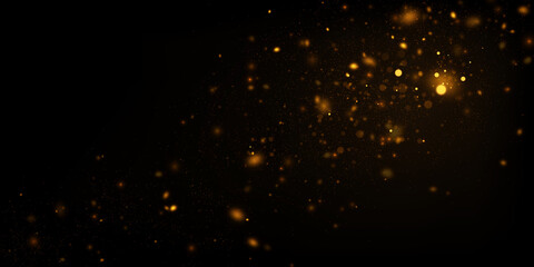 Abstract background with golden glitter dust. Glowing lights, sparkling particles on black.
