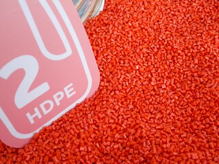 Raw red plastic bead from recycle material ready to be process to use. Recycle concept, Background