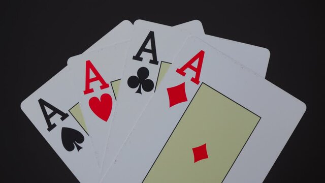four aces are approaching on a black background