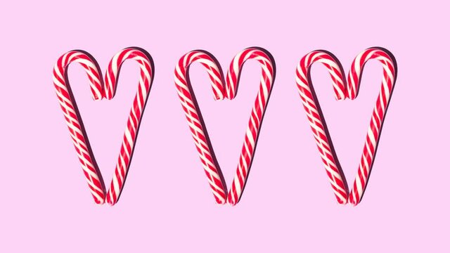 Christmas candy red and white heart shaped staffs increase and decrease on a pink background
