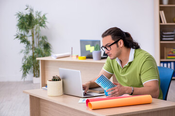 Young male designer working in the office