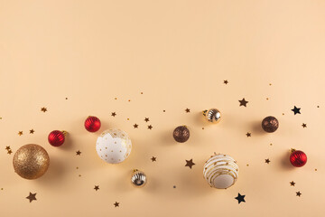 Minimalistic round Christmas white, red and gold balls on a neutral background with stars. Top view and copy space