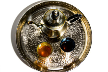 Group of teapot and glasses of oriental tea on a tray on white background