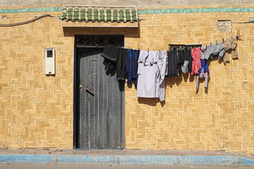 Traditional moroccan house with drying clothes hanging on rope