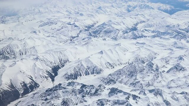 Aerial view of central Karakoram or Karakorum range in Pakistan, second highest mountain range in the world, with snowcapped mountains, peaks, valleys & glaciers.