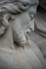 Full frame image of sculpted Jesus face on Victorian cemetery pieta. Selective focus draws the eye toward the facial features.