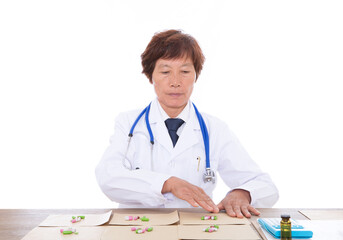 Female doctor in white coat is dispensing medicine for patient