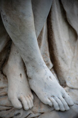 Beautiful Victorian cemetery pieta statue, Jesus's feet show stigmata. Full frame in natural light. Beautiful detail.