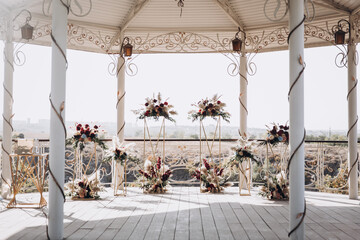 wedding decor, arch and floristry, outdoor ceremonies, white chairs
