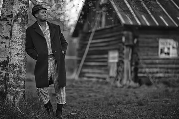vintage man young village black and white, eastern europe style, retro coat and boots