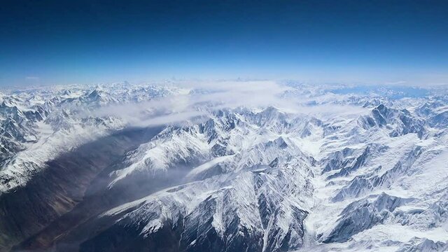 Aerial view of central Karakoram or Karakorum range in Pakistan, second highest mountain range in the world, with snowcapped mountains, peaks, valleys & glaciers.