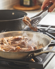 Baby back ribs meat being prepared on a steel pan