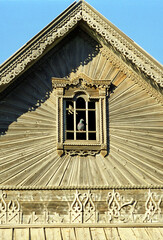 Fragment of the pediment of an old Russian wooden house from the times of the Russian Empire. There...