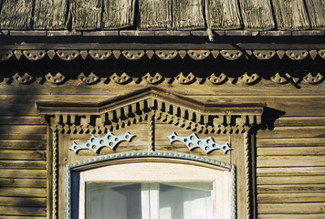Fragment of the window of an old Russian wooden house from the times of the Russian Empire. There...