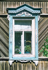 Window of an old Russian wooden house from the times of the Russian Empire. There are carved decorations in the facade decor. Architecture of the European part of Russia (southern city). For various r