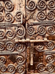 Old metallic door with a lock and decorations