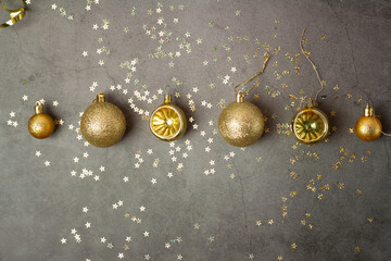 golden christmas decorations balls on dark background.