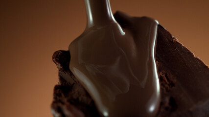 Detail of piece of chocolate with pouring hot chcocolate