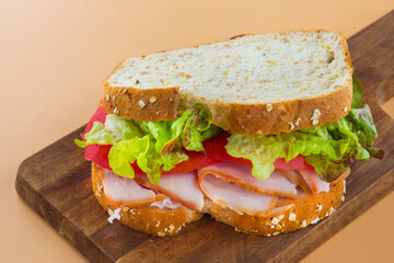 Sandwich of tomato, lettuce and smoked turkey