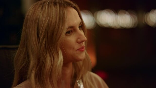 Woman sitting in armchair. Thoughtful female face. Girl licking lips