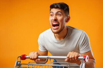 Funny crazy man rushing with shopping trolley to sale