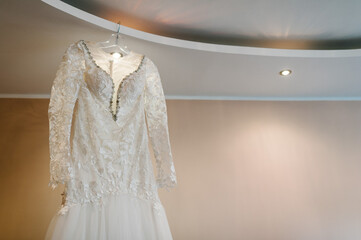 Fashionable beautiful classic lace brides dress in room. morning preparation wedding concept. vintage gown.