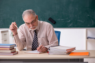 Old male teacher in the classroom