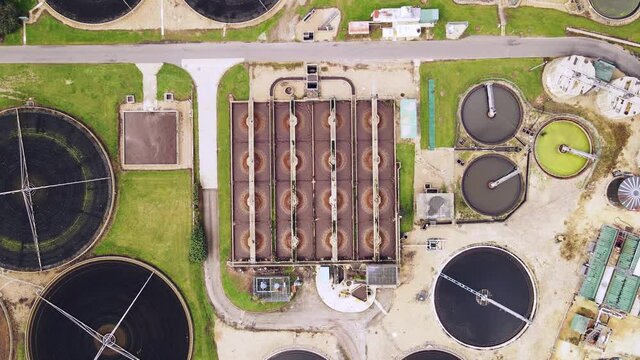 Wide aerial of water purification circle, clean drinking water. Ecosystem of filtration, fresh water and water management. Sewage treatment plant in the sun