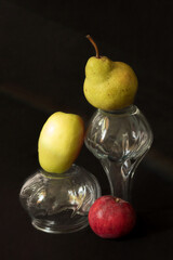 Still life pears and apples on a black background