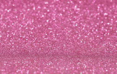 Pink holiday glitter background with selective focus.