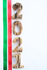 Christmas decoration numbers 2021 and green and red ribbons on white, place for text.
