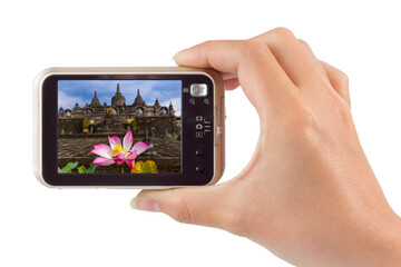 Hand with camera and Buddhist temple in Bali Indonesia (my photo)