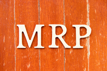 Alphabet letter in word MRP (Abbreviation of Material requirements planning) on old red color wood plate background