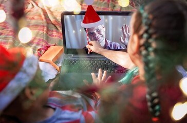 New normal online Christmas celebration. Kids celebrating with family via video chat
