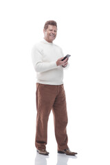 full- length . smiling man reading a message on his smartphone