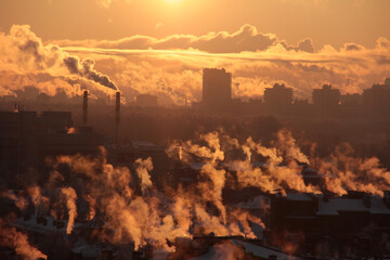 Industrial buildings at sunset and smog. Global warming problem