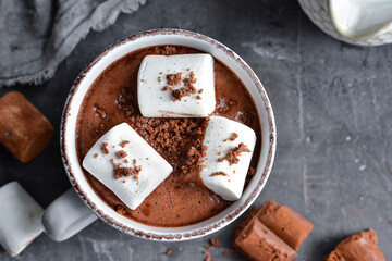 Hot chocolate and marshmallows. Hot Cocoa in a white cup. Dark background. Autumn drink concept. Copy space.