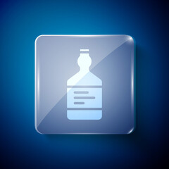 White Tequila bottle icon isolated on blue background. Mexican alcohol drink. Square glass panels. Vector.