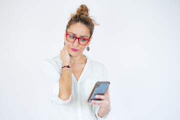 Fototapeta premium Woman reading a text with a concerned look.